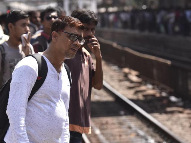 A hassled commuter tries to gauge the situation and looks for a train at Dadar station (Kunal Patil/ Hindustan Times)