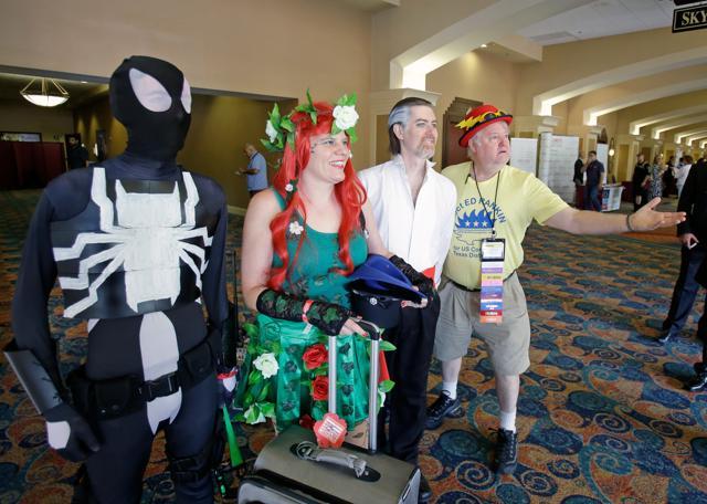 A Libertarian delegate, far right, poses for a photo with comic charters attending a Megacon Convention next door to the National Libertarian Party Convention on Friday in Orlando, Florida. Many of the Libertarian delegates and Megacon attendees were sharing the same hotel near the Orange County Convention Centre. (AP) A Libertarian delegate, far right, poses for a photo with comic charters attending a Megacon Convention next door to the National Libertarian Party Convention on Friday in Orlando, Florida. Many of the Libertarian delegates and Megacon attendees were sharing the same hotel near the Orange County Convention Centre. (AP)