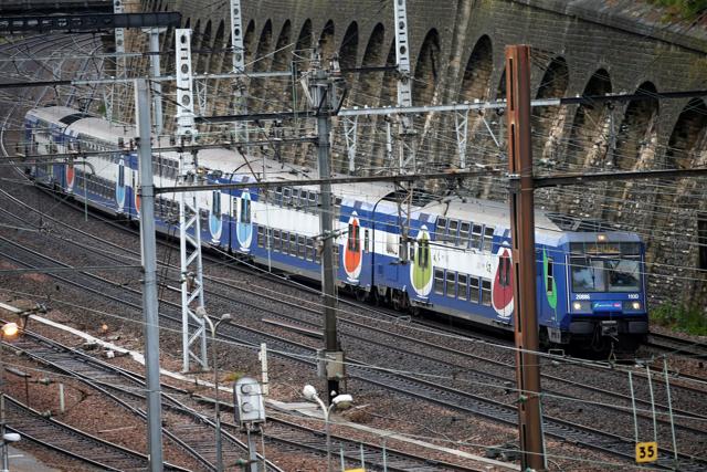 A Transilien, the suburban railway service of French state-owned railway company SNCF, speeds on the railtrack in Charenton-le-Pont near Paris as railway workers start a national railway strike on Tuesday evening. (REUTERS) A Transilien, the suburban railway service of French state-owned railway company SNCF, speeds on the railtrack in Charenton-le-Pont near Paris as railway workers start a national railway strike on Tuesday evening. (REUTERS)