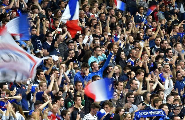 French supporters hold the French National flag as they attend the international friendly football match between France and Cameroon at the Beaujoire stadium, in Nantes, western France. (AFP File Photo) French supporters hold the French National flag as they attend the international friendly football match between France and Cameroon at the Beaujoire stadium, in Nantes, western France. (AFP File Photo)