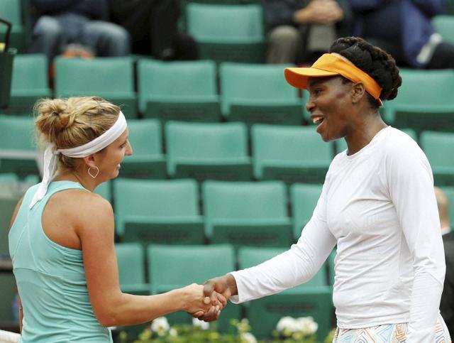 Timea Bacsinszky and Venus Williams shake hands at the net after their match. (AP) Timea Bacsinszky and Venus Williams shake hands at the net after their match. (AP)