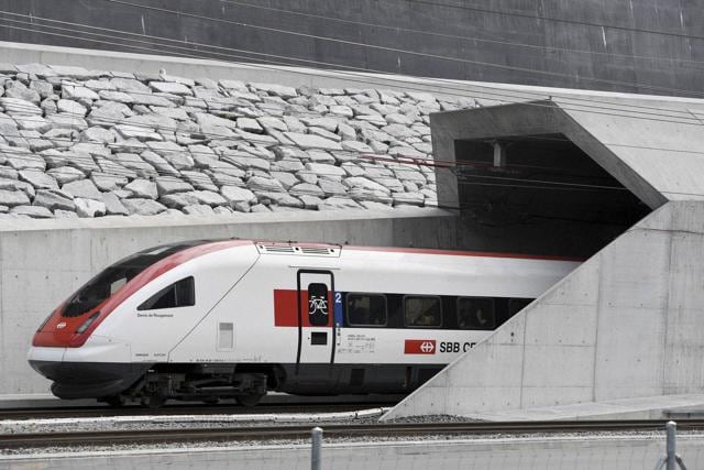 The first train enters and is about to disappear into the tunnel's North portal. (AP)