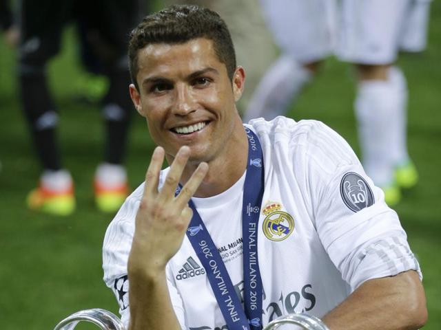 Real Madrid's Cristiano Ronaldo poses with the trophy after the Champions League final match.(AP Photo)