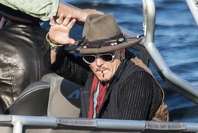 US actor Johnny Depp waves from a boat on his way to the concert with his band Hollywood Vampires at the Grona Lund amusement park in Stockholm. (AFP) US actor Johnny Depp waves from a boat on his way to the concert with his band Hollywood Vampires at the Grona Lund amusement park in Stockholm. (AFP)
