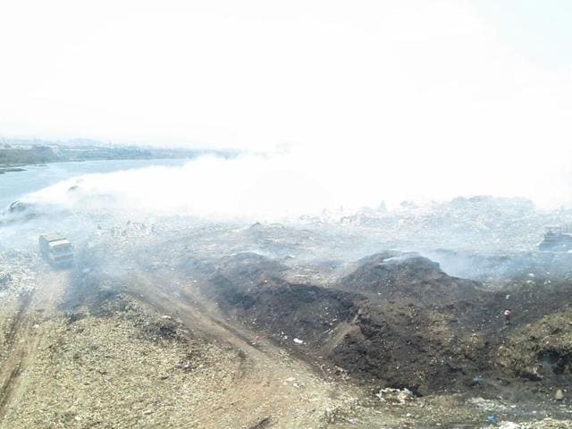 A group of 25 fire officials have been constantly working on the work to tame the fire and smoke at the dumpyard since Tuesday 3.30pm after a major fire broke out spreading across the 4 acre dumping site and emitting thick smoke in the premises (HT) A group of 25 fire officials have been constantly working on the work to tame the fire and smoke at the dumpyard since Tuesday 3.30pm after a major fire broke out spreading across the 4 acre dumping site and emitting thick smoke in the premises (HT)