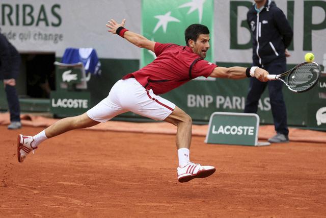 Serbia's Novak Djokovic stretches to return the ball in the fourth round match of the French Open tennis tournament against Spain’s Roberto Bautista Agut at the Roland Garros stadium in Paris, France. (AP Photo) Serbia's Novak Djokovic stretches to return the ball in the fourth round match of the French Open tennis tournament against Spain’s Roberto Bautista Agut at the Roland Garros stadium in Paris, France. (AP Photo)