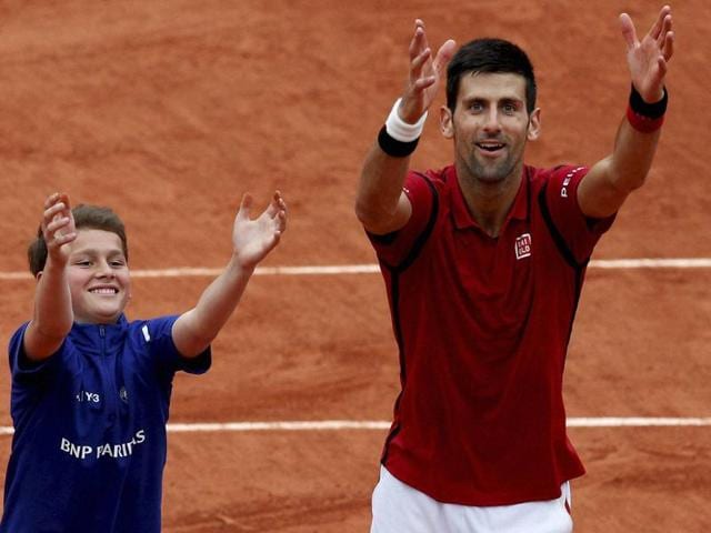 Serbia's Novak Djokovic (right) teaches a ballboy how to celebrate a victory after he defeated Spain's Roberto Bautista Agut during their fourth round match of the French Open tennis tournament at the Roland Garros stadium. (AP Photo) Serbia's Novak Djokovic (right) teaches a ballboy how to celebrate a victory after he defeated Spain's Roberto Bautista Agut during their fourth round match of the French Open tennis tournament at the Roland Garros stadium. (AP Photo)
