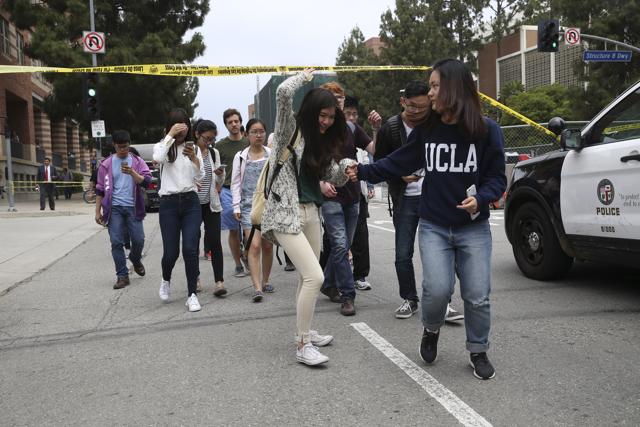 Students cross under police tape at UCLA, in Los Angeles, June 1, 2016. (NYT) Students cross under police tape at UCLA, in Los Angeles, June 1, 2016. (NYT)
