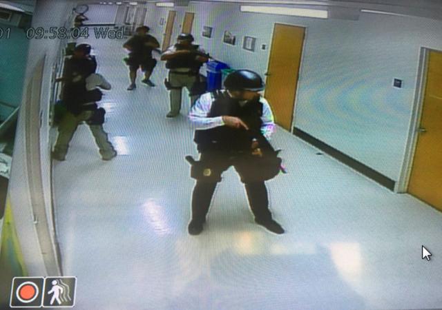 Police officers search corridors and rooms after the report of an active shooter on a UCLA campus in Los Angeles. (REUTERS)
