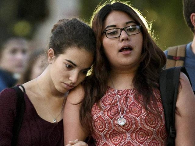 Catania Billalovos, left, holds onto Mireia Villanova, right, as they stand in front of a vigil for professor William Klug at the University of California, Los Angeles, Thursday. (AP Photo) Catania Billalovos, left, holds onto Mireia Villanova, right, as they stand in front of a vigil for professor William Klug at the University of California, Los Angeles, Thursday. (AP Photo)