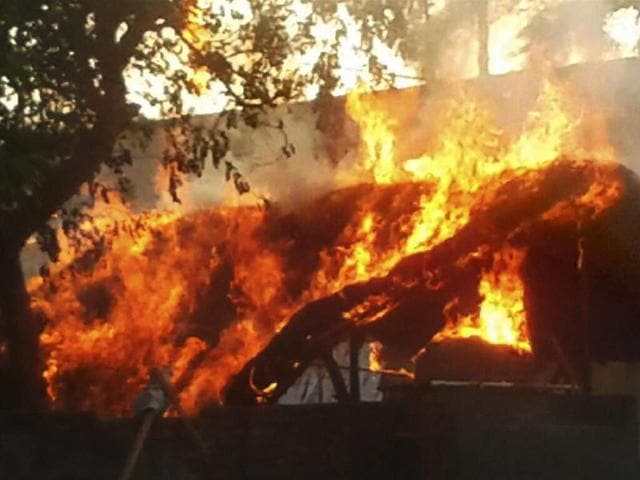 A house is set on fire after clashes between the police and the encroachers who were being evicted from Jawahar Bagh in Mathura on June 2, 2016. (PTI)