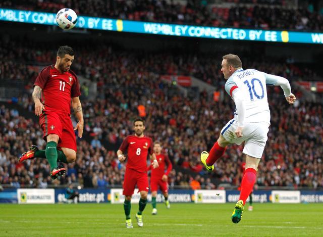 England's striker Wayne Rooney (right) heads the ball past Portugal's Vieirinha during the friendly football match between England and Portugal at Wembley stadium in London. (AFP Photo)