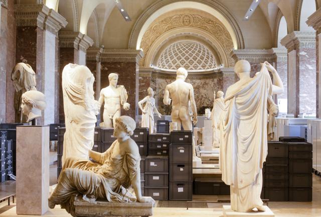 Plastic boxes placed between sculptures as artworks are packed to be moved from the exhibition hall, as visitors are turned away from the entrance of the Musee de Louvre which is closed due to the unusually high water level of the nearby river Seine in Paris on Friday. (AP)