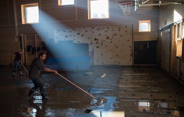 Helpers remove the mud from a flooded gym in Simbach am Inn, southern Germany on Thursday. (AFP)