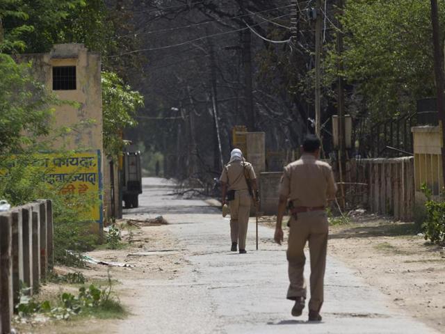Policemen patrol the entrance to a park where clashes between police and protesters claimed several lives in Mathura on June 2, 2016. (AP)