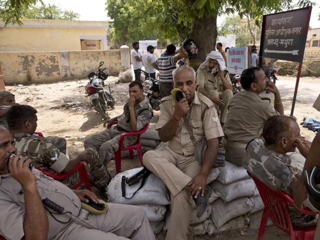 Police personnel guard an entrance to a park where clashes between police and protesters claimed several lives in Mathura on June 2, 2016. (AP)