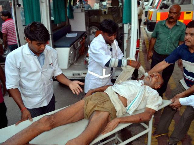 An encroacher being taken to the district hospital on a stretcher after he got injured during the clashes on June 2, 2016. (PTI)