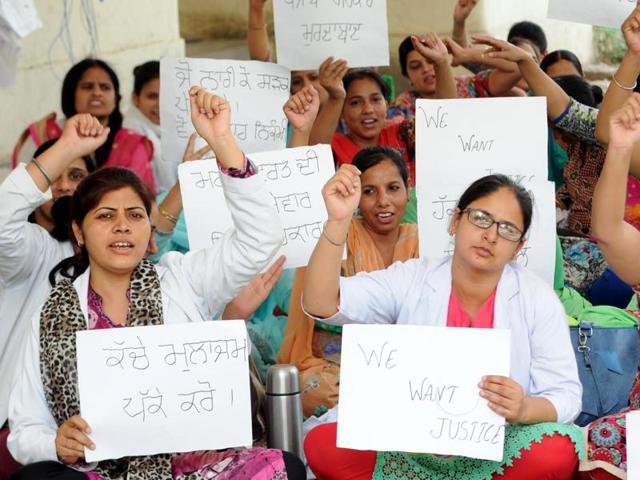 Members of the nursing association closing the OPD ward during a protest against the Punjab government at Rajindra Hospital on Thursday.(Bharat Bhushan/HT Photo)