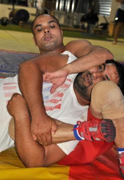 Wrestler Vinod Kumar (top) spars with another wrestler at a gym in Melbourne, Australia. (REUTERS)