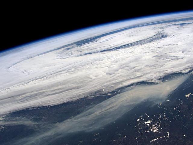 The smoke plume (bottom) from large wildfires in and around Ft McMurray, Alberta, Canada is seen in a picture taken by NASA astronaut Jeff Williams from the International Space Station May 11, 2016. (REUTERS) The smoke plume (bottom) from large wildfires in and around Ft McMurray, Alberta, Canada is seen in a picture taken by NASA astronaut Jeff Williams from the International Space Station May 11, 2016. (REUTERS)