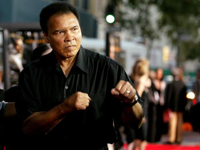 Boxing legend Muhammad Ali (right) jabs at photographers while arriving at the Orpheum Theatre for the premiere of the film "Collateral" in Los Angeles. (Reuters Photo) Boxing legend Muhammad Ali (right) jabs at photographers while arriving at the Orpheum Theatre for the premiere of the film "Collateral" in Los Angeles. (Reuters Photo)