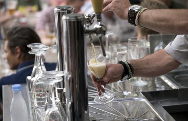 A worker pours a glass of beer for customers at the Halve Maan Brewery in Bruges, Belgium. (AP) A worker pours a glass of beer for customers at the Halve Maan Brewery in Bruges, Belgium. (AP)