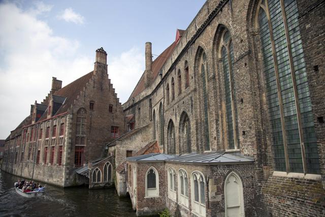 Tourists ride in a boat down a main canal past the Hospital St. Jan in Bruges, Belgium on Thursday, May 26, 2016. (AP) Tourists ride in a boat down a main canal past the Hospital St. Jan in Bruges, Belgium on Thursday, May 26, 2016. (AP)
