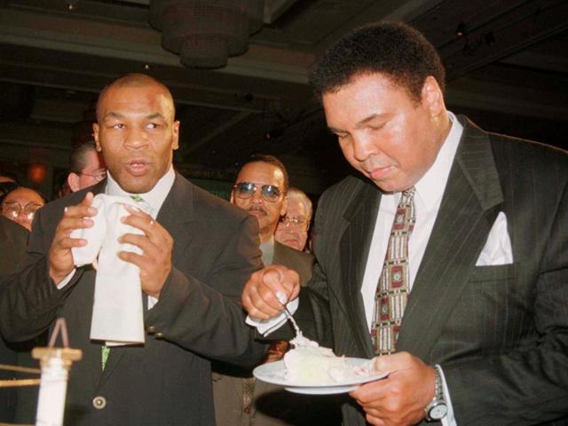 Boxing great Muhammad Ali (right) eats a piece of his birthday cake as boxer Mike Tyson looks on at the MGM Grand hotel in Las Vegas, Nevada. (Reuters Photo) Boxing great Muhammad Ali (right) eats a piece of his birthday cake as boxer Mike Tyson looks on at the MGM Grand hotel in Las Vegas, Nevada. (Reuters Photo)