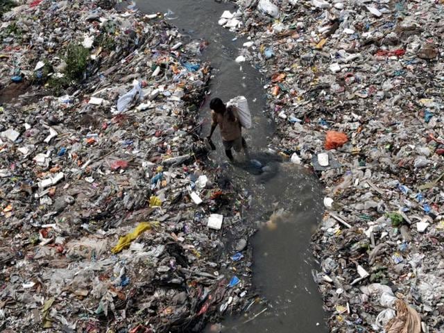 A rag picker searches for reusable items in the pile of garbage in a polluted river Tawi. (Nitin Kanotra/HT Photo) A rag picker searches for reusable items in the pile of garbage in a polluted river Tawi. (Nitin Kanotra/HT Photo)