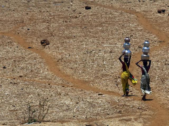 Women walk home after collecting drinking water from a well at Mengal Pada in Thane district in Maharashtra. Greenpeace India has listed Maharashtra, Madhya Pradesh, Uttar Pradesh, Karnataka, Andhra Pradesh, Telangana, Chhattisgarh as drought-hit states. (AP) Women walk home after collecting drinking water from a well at Mengal Pada in Thane district in Maharashtra. Greenpeace India has listed Maharashtra, Madhya Pradesh, Uttar Pradesh, Karnataka, Andhra Pradesh, Telangana, Chhattisgarh as drought-hit states. (AP)