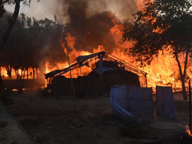 A fire burns after police attempted to evict thousands of followers of a cult from Jawahar Bagh park in Mathura. Clashes between police and the followers left 24 people dead, including to police officers on June 3. Police suspect cult leader Ram Vriksha Yadav may have died in the fire. (AFP Photo) A fire burns after police attempted to evict thousands of followers of a cult from Jawahar Bagh park in Mathura. Clashes between police and the followers left 24 people dead, including to police officers on June 3. Police suspect cult leader Ram Vriksha Yadav may have died in the fire. (AFP Photo)