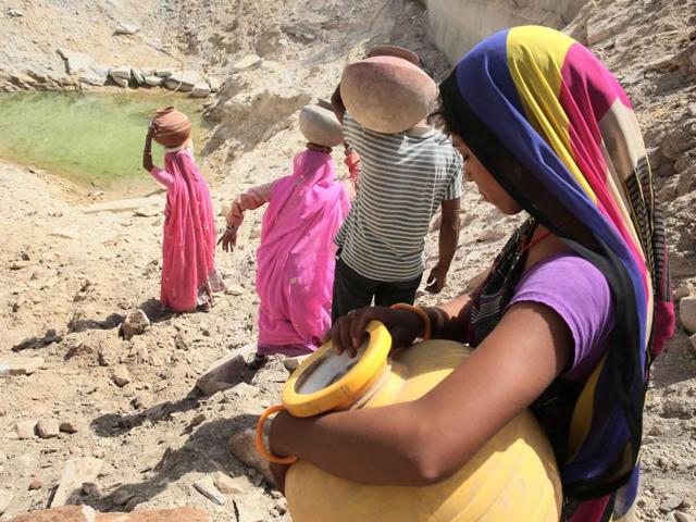 Villagers head towards a water hole atop a hill whose groundwater level has risen due to water harvesting at Pipalantri village in Rajsamand district, Rajasthan. (Himanshu Vyas/HT Photo) Villagers head towards a water hole atop a hill whose groundwater level has risen due to water harvesting at Pipalantri village in Rajsamand district, Rajasthan. (Himanshu Vyas/HT Photo)