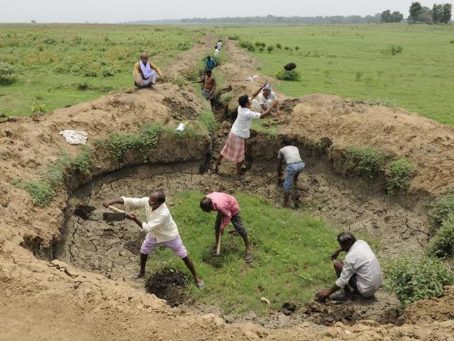 Around 205 villagers of Rambon Bagdipara at Raghunathpur-II block in Purulia district dig a canal and a catchment area. While the canal would help them to supply water from the Damodar River to irrigate the fields, the catchment would help them to harvest rainwater. Even though Purulia gets ample rain every year the high run off ratio makes it difficult to sustain agriculture which makes the district drought prone. (Samir Jana/HT Photo) Around 205 villagers of Rambon Bagdipara at Raghunathpur-II block in Purulia district dig a canal and a catchment area. While the canal would help them to supply water from the Damodar River to irrigate the fields, the catchment would help them to harvest rainwater. Even though Purulia gets ample rain every year the high run off ratio makes it difficult to sustain agriculture which makes the district drought prone. (Samir Jana/HT Photo)