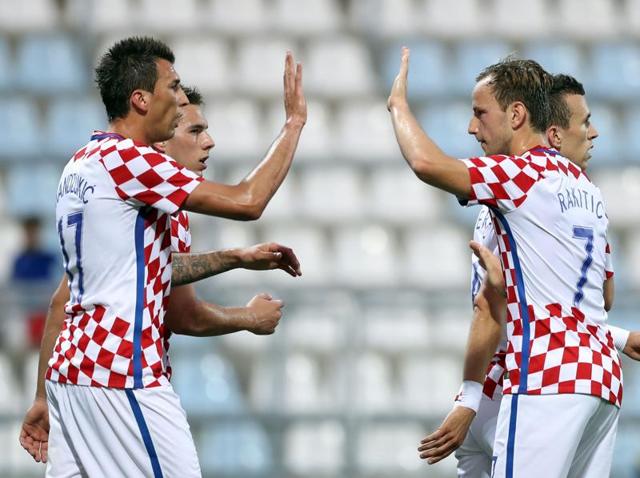 Ivan Rakitic, right, scored once while Mario Mandzukic, center, grabbed a hat-trick.(AP)