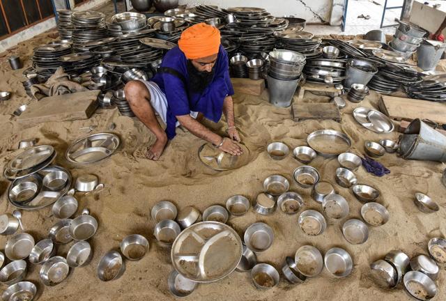 A student cleaning utensils at the campus. (Gurpreet Singh/HT Photo) A student cleaning utensils at the campus. (Gurpreet Singh/HT Photo)