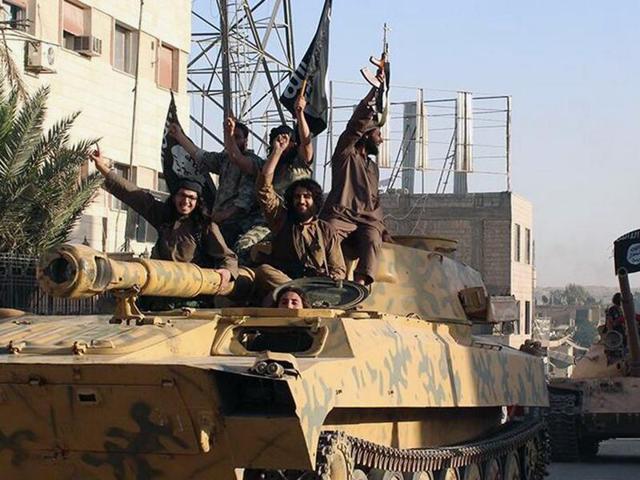 In this undated file image, fighters from the Islamic State group ride tanks during a parade in Raqqa, Syria. (AP) In this undated file image, fighters from the Islamic State group ride tanks during a parade in Raqqa, Syria. (AP)