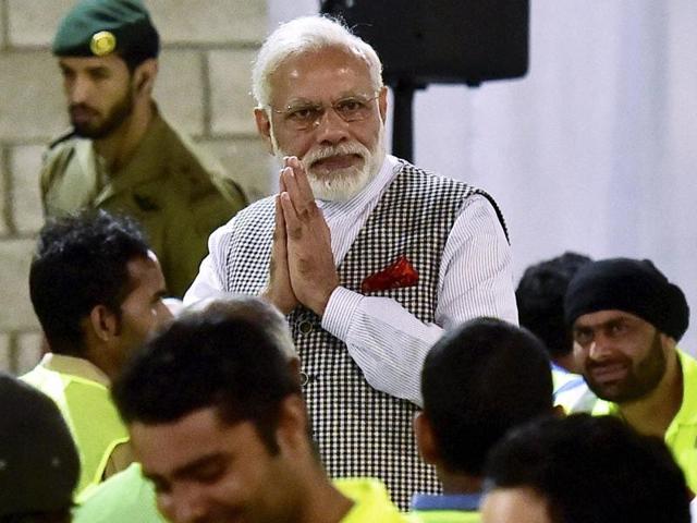 Prime Minister Narendra Modi greets Indian workers working in Doha at a camp in Qatar on Saturday.(PTI)