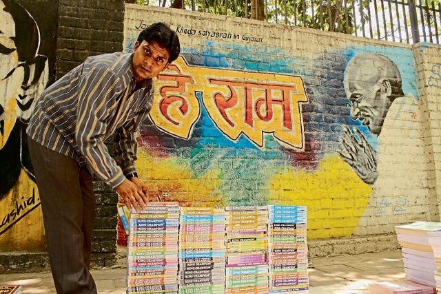 Guiding light: The Campus Journalists’ picture of the week by Shivam Parashar shows a bookseller at north campus with Gandhiji smiling benignly, almost as if he’s blessing the books. (Hindustan Times)