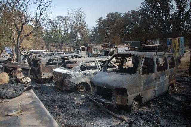 Among the hollow, burned out vehicles are Tata Safaris, Toyota Innovas, trucks, tractors, mini-DCMs and motorcycles. But more disturbing than the empty vehicle shells are the many slippers and shoes that indicate the stampede that followed when chaos broke. (Antram/HT Photo)