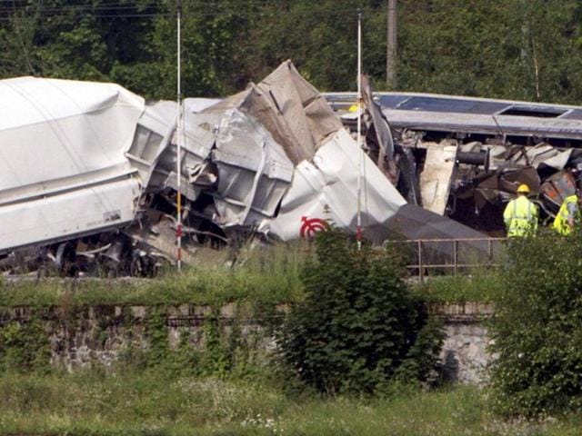 Investigators stand near the wreckage of a passenger and freight train after they collided in Hermalle-sous-Huy, near Liege, Belgium on Monday. (AP) Investigators stand near the wreckage of a passenger and freight train after they collided in Hermalle-sous-Huy, near Liege, Belgium on Monday. (AP)