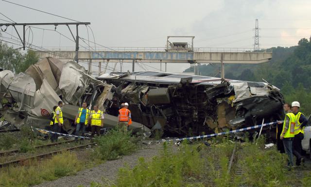 Workers stand at the scene of a collision between a freight train and a passengers train. (AFP) Workers stand at the scene of a collision between a freight train and a passengers train. (AFP)