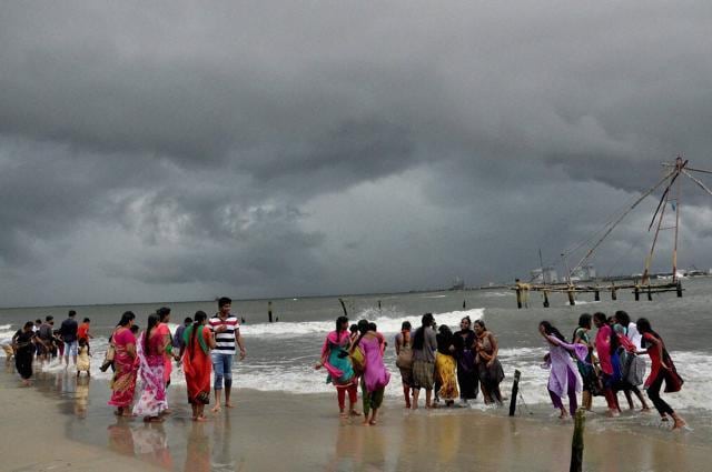 Girls enjoy a cloudy day on a beach in Kochi against the backdrop of monsoon clouds on Sunday (PTI) Girls enjoy a cloudy day on a beach in Kochi against the backdrop of monsoon clouds on Sunday (PTI)