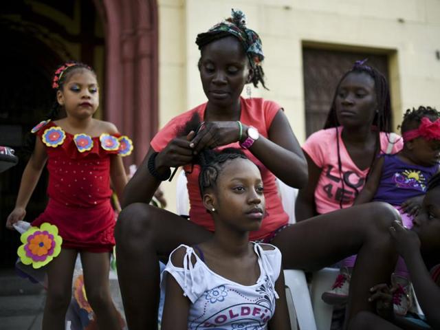 The slaves would sit down to braid the hair of their children after long and back-breaking hours of work. Thus were born the unique patterns of Afro-Colombian hairstyles. (AFP) 