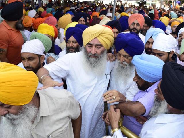 SAD leader Ranjit Singh Brahmpura walking through the crowd at the Golden Temple in Amritsar on Monday. (Gurpreet Singh/HT)