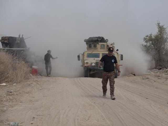 Iraq's elite counterterrorism forces move their vehicles on the front line in Fallujah on Sunday. Iraqi forces are pushing their way into the city to retake it from Islamic State militants.(AP)