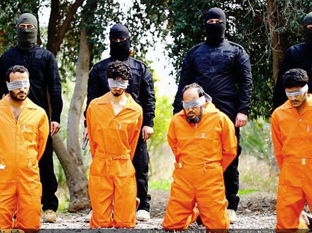 This undated image released by a militant website shows members of the Islamic State as they prepare to kill men who were allegedly spying for the US-led coalition in the province of Salah al-Din, Iraq. (AP) This undated image released by a militant website shows members of the Islamic State as they prepare to kill men who were allegedly spying for the US-led coalition in the province of Salah al-Din, Iraq. (AP)