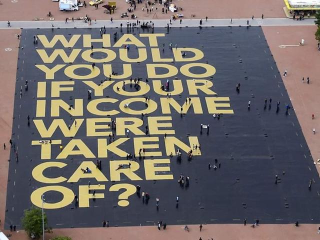 This photo taken in Plainpalais place in Geneva shows a giant poster reading “What would you do if your income was taken care of?”, setting the Guinness World Record for the largest poster ever printed. (AFP Photo) This photo taken in Plainpalais place in Geneva shows a giant poster reading “What would you do if your income was taken care of?”, setting the Guinness World Record for the largest poster ever printed. (AFP Photo)