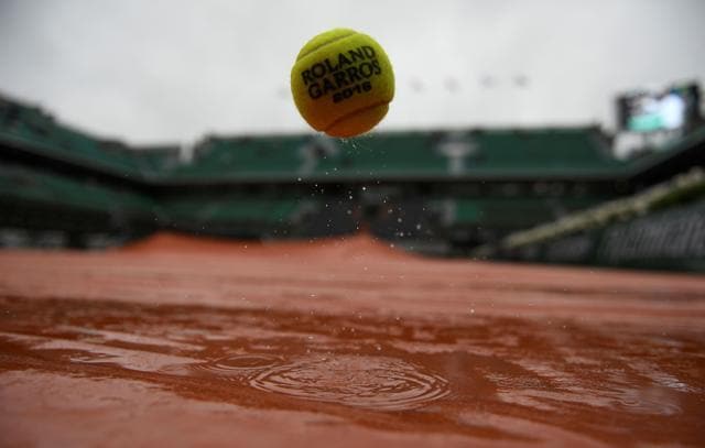 An official ball on the tarp covering the Philippe Chatrier central court as the rains falls over the Roland Garros stadium. (AFP Photo) An official ball on the tarp covering the Philippe Chatrier central court as the rains falls over the Roland Garros stadium. (AFP Photo)