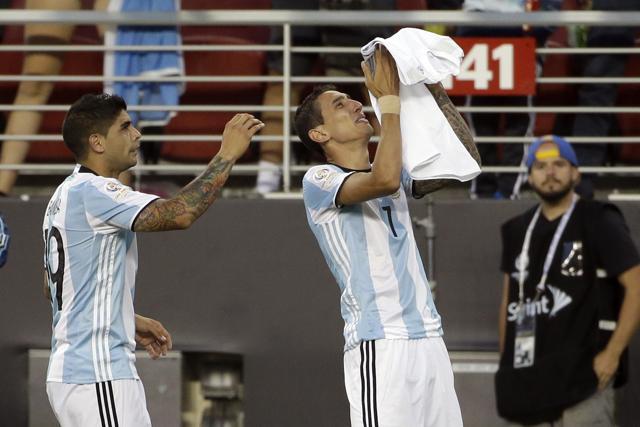 Angel Di Maria, right, holds a t-shirt that reads "grandmother I will miss you a lot" after scoring against Chile. (AP)