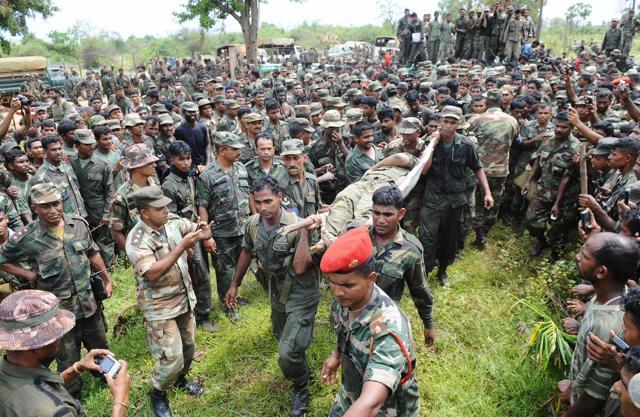 In this photograph taken on May 19, 2009, Sri Lankan soldiers carry the remains of Tamil Tiger rebel leader Velupillai Prabhakaran in the district of Mullaittivu. (AFP file photo) In this photograph taken on May 19, 2009, Sri Lankan soldiers carry the remains of Tamil Tiger rebel leader Velupillai Prabhakaran in the district of Mullaittivu. (AFP file photo)